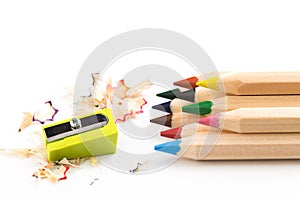 Wooden colorful pencils on a white background, pencil sharpeners