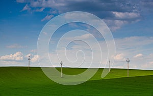 Wooden columns of power lines on the field