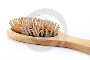 Wooden comb brush with lost hair