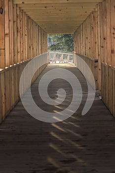 Wooden construction across the glacial river. Modern bridge made of solid oak