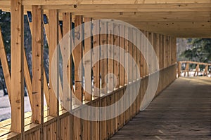 Wooden construction across the glacial river. Modern bridge made of solid oak