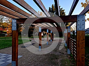 wooden construction of the bus stop, shelter of a gazebo pergola.