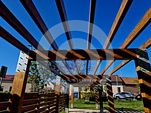 wooden construction of the bus stop, shelter of a gazebo pergola