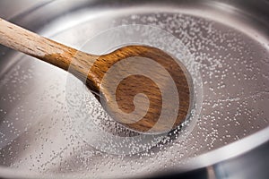 Wooden Cooking Spoon In A Stainless Pot With Boiling Water