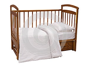 Wooden cot with bedding isolated on white background