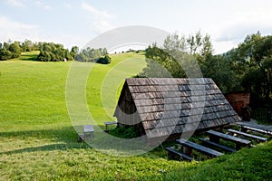 Wooden cottage and green grass in the middle of nowhere