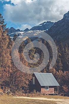 Wooden cottage house in the forest in the mountains with snow