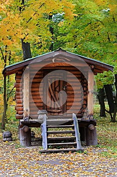 Wooden cottage in the middle of the park.