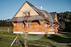 Wooden cottage in nature in sunny day. Recreation center in the mountains. Modern eko hausing in nature.