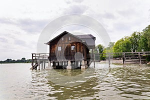 Wooden cottage on pier on the lake Ammersee in Inning am Ammersee, Germany