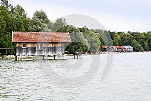 Wooden cottage on pier on the lake Ammersee in Inning am Ammersee, Germany