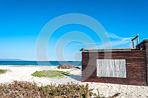 Wooden cottage with reeds window on the beach