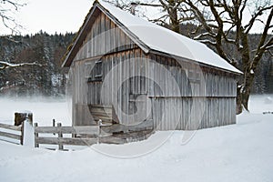 Wooden cottage in snow covered country