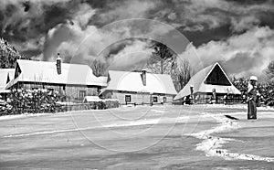 Wooden cottagec covered by snow in village Vlkolinec, Slovakia