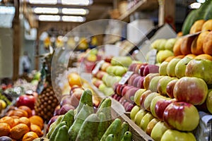 A wooden counter with a variety of ripe fruit on the market. Healthy nutrition, vitamins and vegetarianism