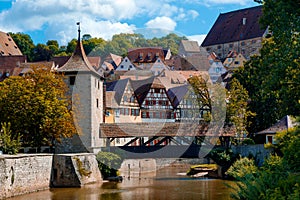 Wooden covered bridge and old tower in the historic center of Schwarz hall on the Kocher river on a summer day. Baden-Wurttemberg photo