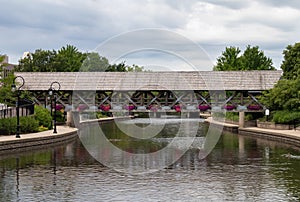 Wooden Covered Bridge over the DuPage River along the Naperville Riverwalk in Suburban Naperville Illinois during Summer photo