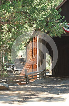 Wooden covered bridge over a river in the Sierras photo