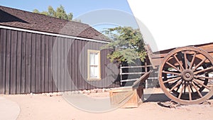 Wooden covered wagon on wheels, wild west pioneer ranch. Western farm or saloon.