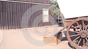 Wooden covered wagon on wheels, wild west pioneer ranch. Western farm or saloon.