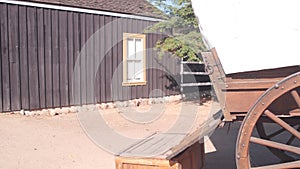 Wooden covered wagon on wheels, wild west pioneer ranch. Western farm or saloon.