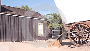 Wooden covered wagon on wheels, wild west pioneer ranch. Western farm or saloon.