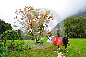 Wooden cow with red Swiss ensign in Interlaken