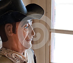 Wooden cowboy at the window