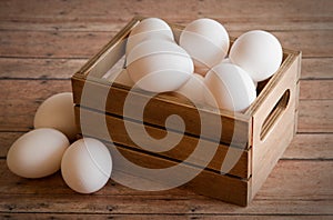 Wooden Crate of Fresh Eggs on a wood plank background board