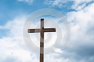 wooden cross against a cloudy sky