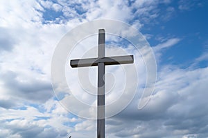 wooden cross against a cloudy sky