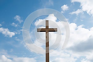 wooden cross against a cloudy sky