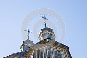 Wooden Cross Background. Wooden cross on a simple steeple set against a blue sky. Church Roof with a cross. Church