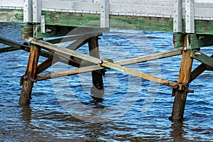 Wooden cross beam supports holding up walkway in lake water - Anne Kolb / West Lake Park, Hollywood, Florida, USA