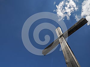 Wooden cross on blue sky background
