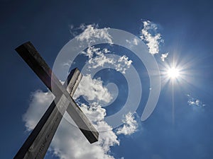 Wooden cross on blue sky background