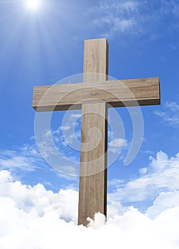 Wooden cross in cloudful blue sky