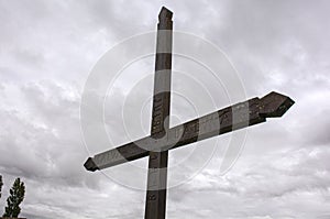wooden cross with cloudy sky