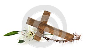 Wooden cross, crown of thorns and blossom lilies photo