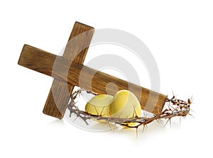 Wooden cross, crown of thorns and Easter eggs