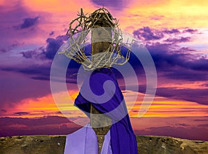 Wooden cross with crown of thorns and fabric