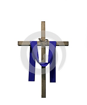 Wooden cross draped with purple fabric and thorns