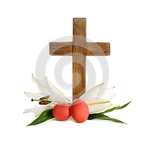 Wooden cross, Easter eggs and blossom lilies on white