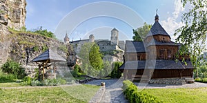 Wooden Cross Exaltation Church against mediaeval fortress, Kamianets-Podilskyi, Ukraine