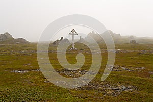 Wooden cross in the fog.