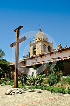 Wooden cross in front of Mission belltower photo