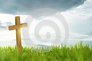 Wooden cross on green grass