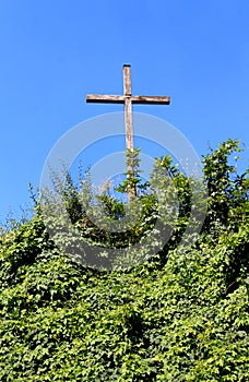 Wooden cross on the green hill