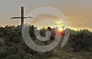 Wooden Cross on Hillside at Dawn