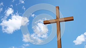 Wooden cross isolated on the blue sky.